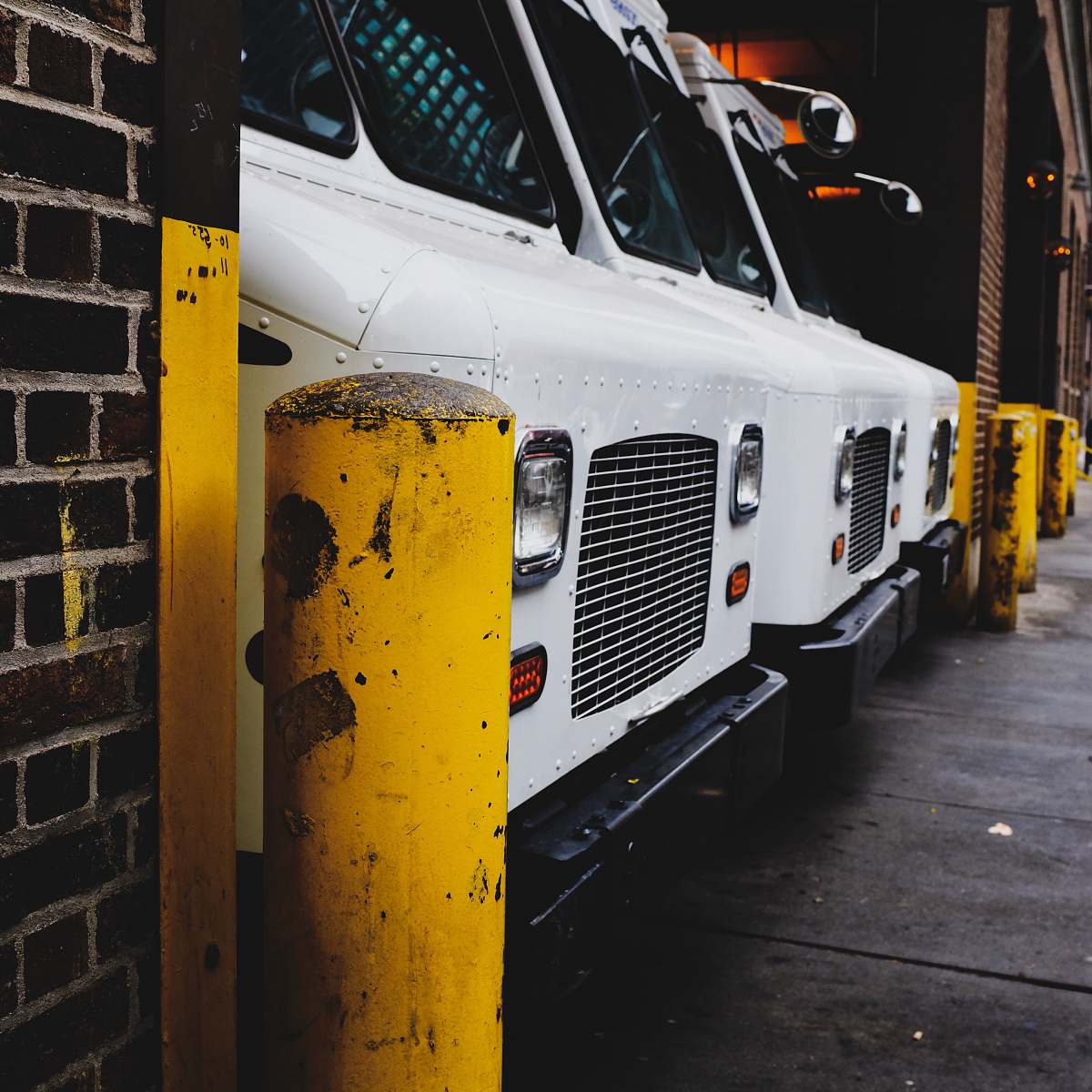 van three white vehicle parked on garage vehicle